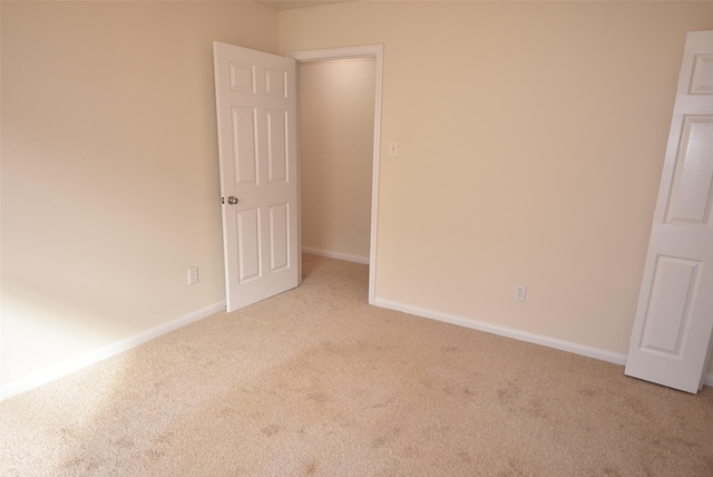 spare room featuring light colored carpet