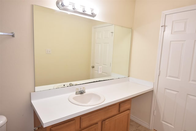 bathroom with tile patterned floors, vanity, and toilet