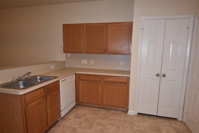 kitchen featuring kitchen peninsula, sink, white dishwasher, and light tile patterned floors