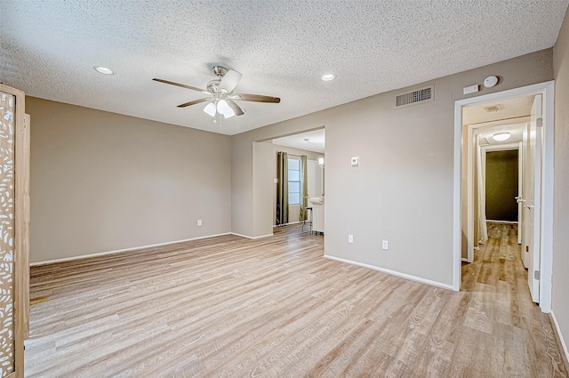 unfurnished room with ceiling fan, a textured ceiling, and light hardwood / wood-style flooring