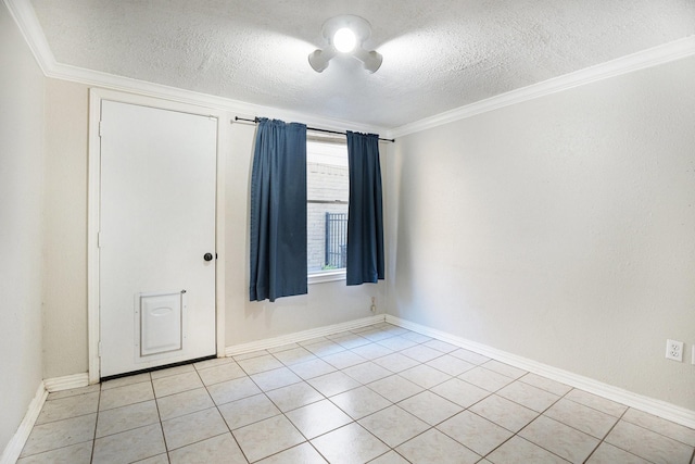 empty room featuring light tile patterned flooring, a textured ceiling, and ornamental molding