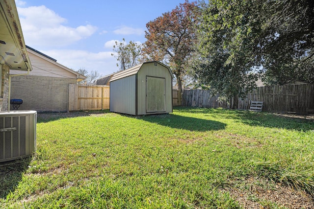 view of yard with central air condition unit and a storage unit