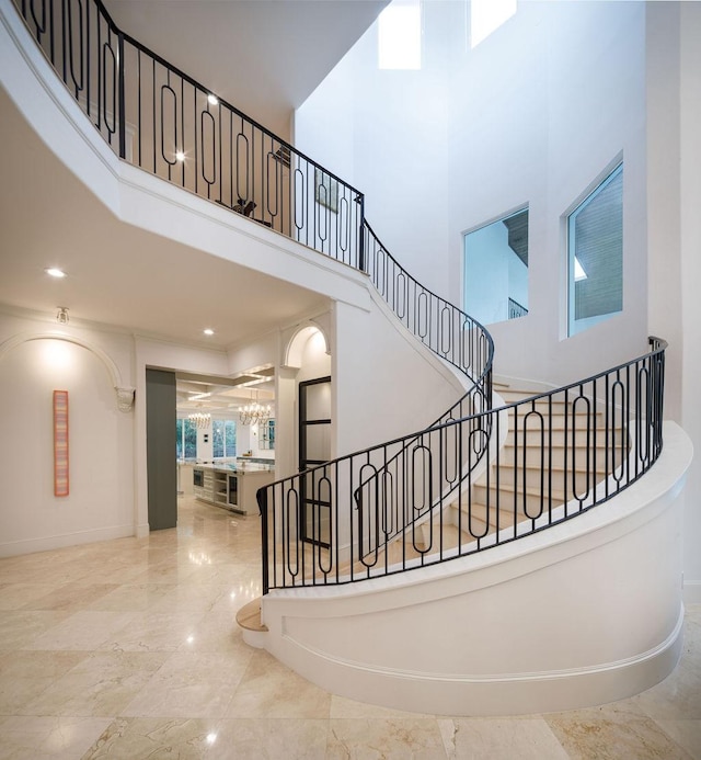 staircase with a high ceiling