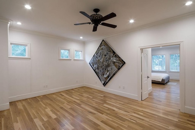 spare room with light wood-type flooring and a wealth of natural light