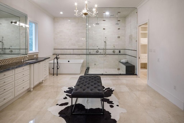 bathroom with a notable chandelier, vanity, crown molding, and plus walk in shower