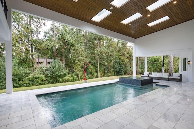 view of swimming pool featuring an in ground hot tub, an outdoor living space, and a patio