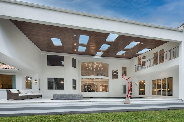 rear view of property featuring an outdoor living space