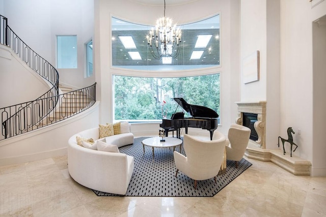 sitting room with a towering ceiling and a chandelier