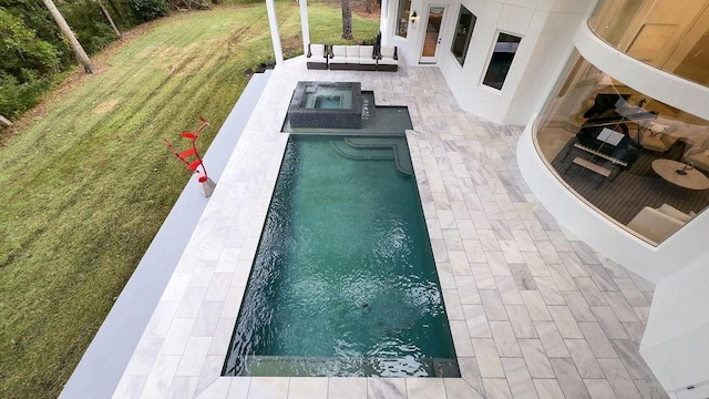 view of pool with outdoor lounge area, a yard, an in ground hot tub, and a patio