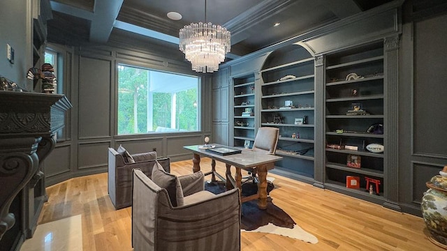 office area featuring beam ceiling, ornamental molding, light wood-type flooring, and an inviting chandelier