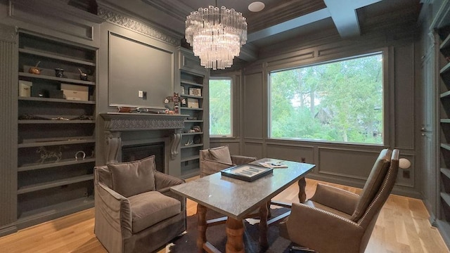 sitting room featuring coffered ceiling, crown molding, an inviting chandelier, beamed ceiling, and light hardwood / wood-style floors