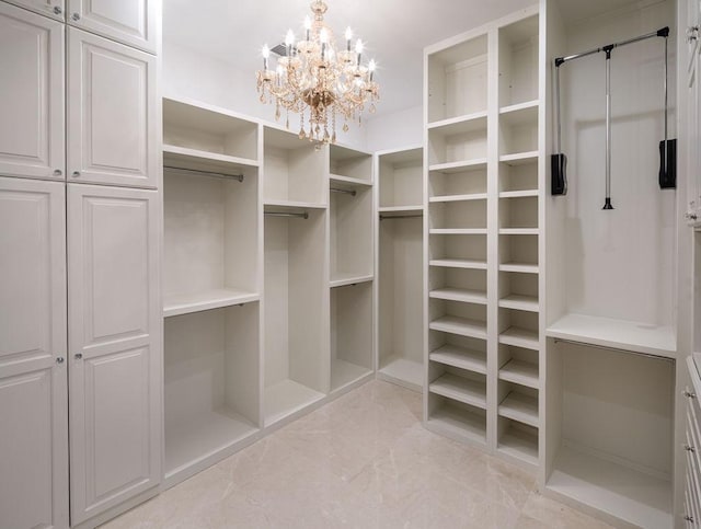 walk in closet with a chandelier