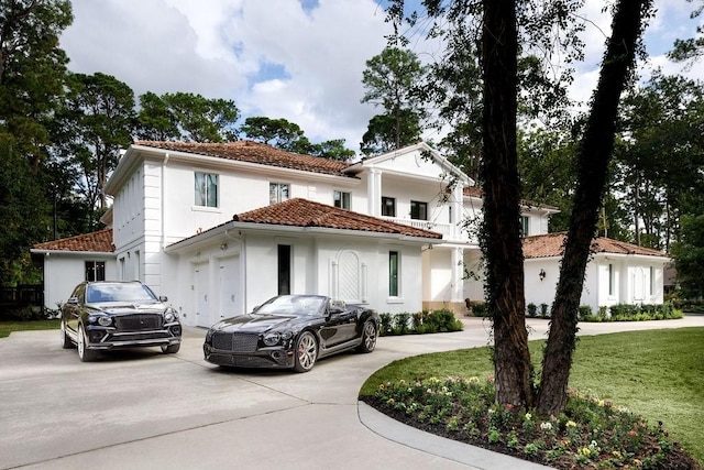 mediterranean / spanish home with a front yard