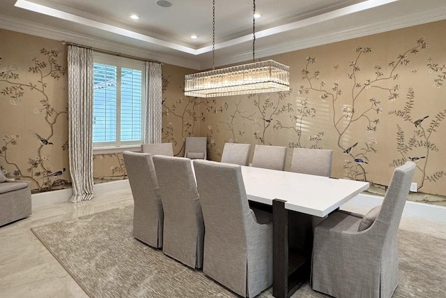 dining area featuring a notable chandelier, crown molding, and a tray ceiling