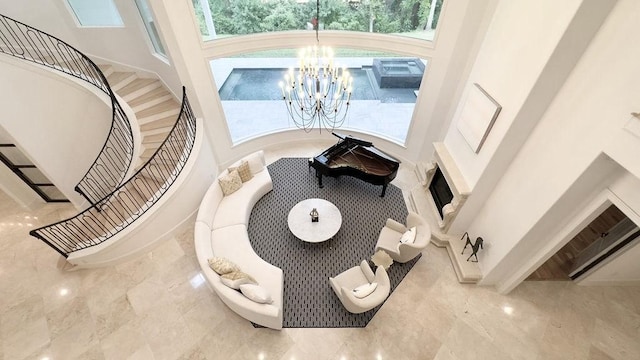 interior space featuring a towering ceiling, an inviting chandelier, and a wealth of natural light