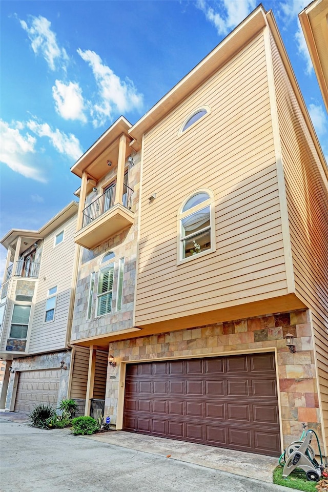 view of front of home featuring a balcony and a garage