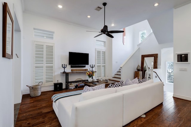 living room with ceiling fan, dark hardwood / wood-style flooring, and ornamental molding