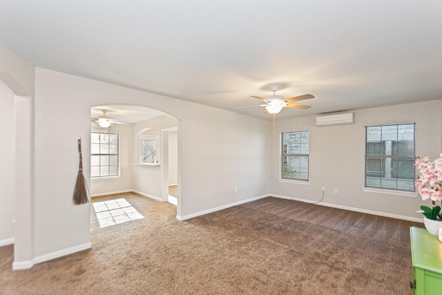 unfurnished room featuring a wall mounted air conditioner, carpet flooring, and ceiling fan