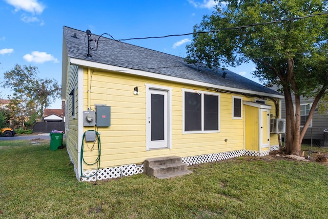 exterior space with cooling unit and a front yard