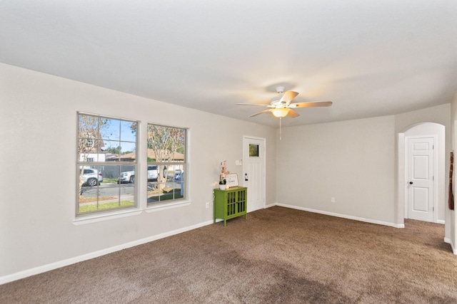 carpeted spare room with ceiling fan