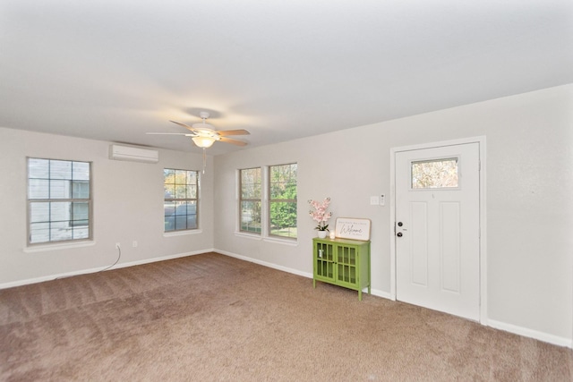 carpeted foyer with ceiling fan and a wall mounted air conditioner