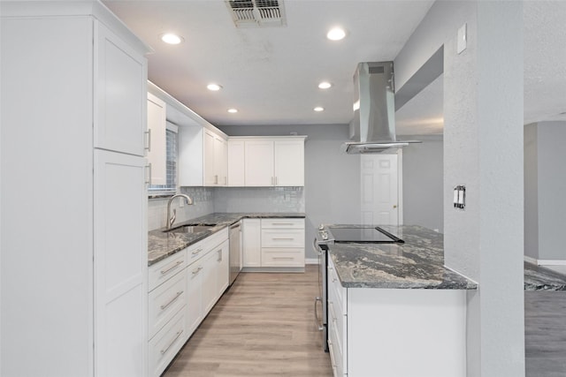 kitchen featuring sink, stainless steel appliances, extractor fan, light hardwood / wood-style floors, and white cabinets