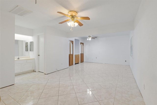 tiled spare room with ceiling fan