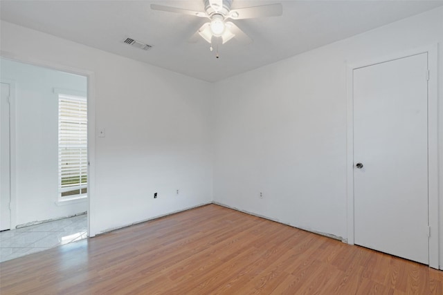 unfurnished room featuring ceiling fan and light hardwood / wood-style flooring