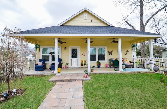 back of house with a lawn, ceiling fan, and a patio