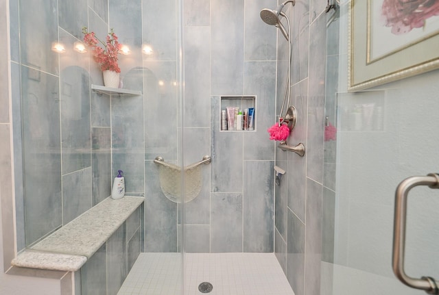 bathroom with a shower with shower door