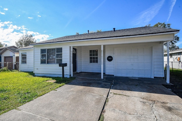 ranch-style house featuring a front yard and a garage