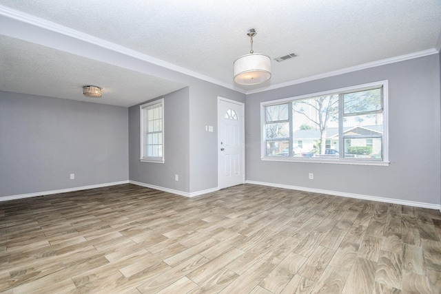 entryway with crown molding, a textured ceiling, and light wood-type flooring