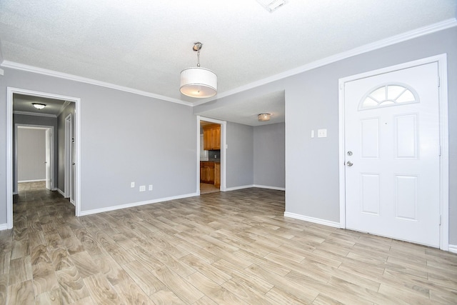 entryway featuring crown molding, light hardwood / wood-style floors, and a textured ceiling