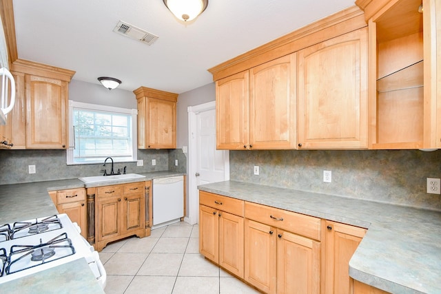 kitchen featuring light brown cabinetry, backsplash, white appliances, sink, and light tile patterned floors