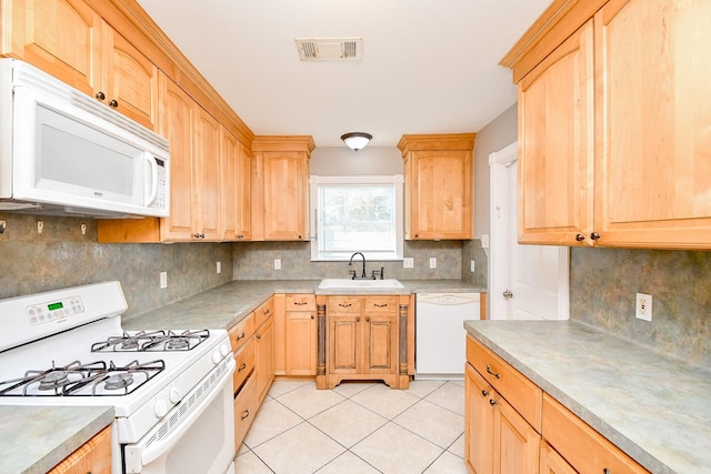 kitchen with light brown cabinetry, tasteful backsplash, white appliances, sink, and light tile patterned floors