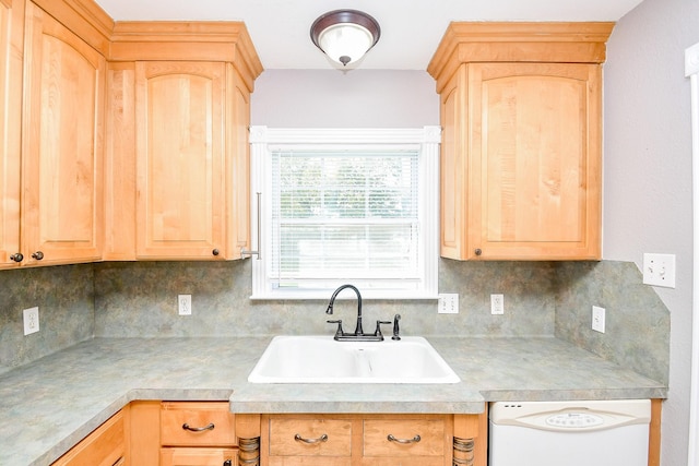 kitchen with backsplash, light brown cabinetry, dishwasher, and sink