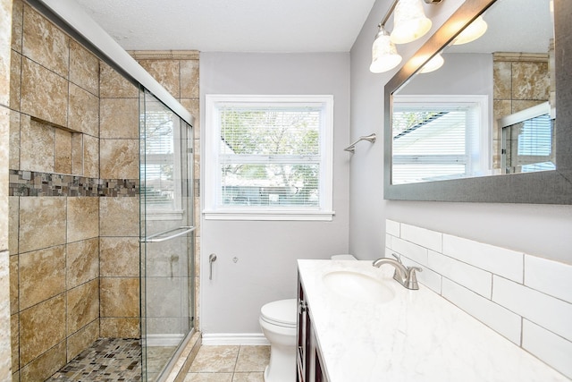 bathroom featuring vanity, tile patterned flooring, toilet, walk in shower, and a textured ceiling