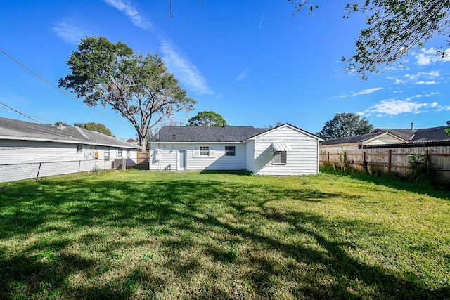 rear view of property featuring a yard