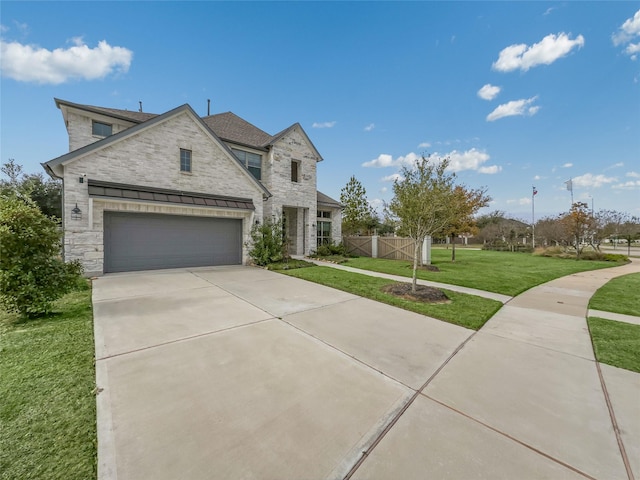 view of front of house with a front yard and a garage