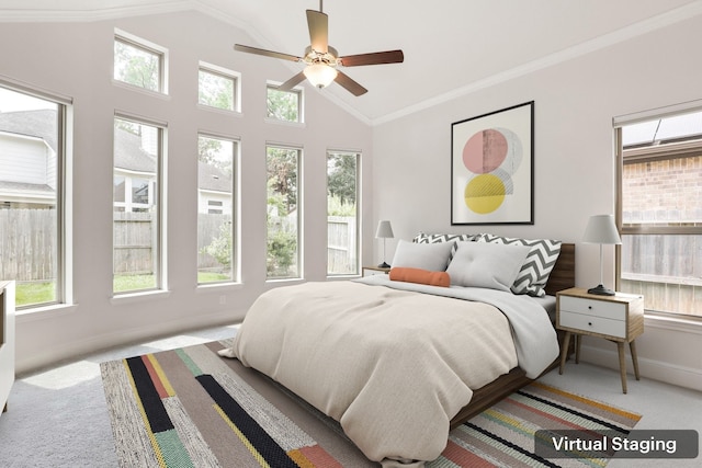 carpeted bedroom with ceiling fan, lofted ceiling, and crown molding