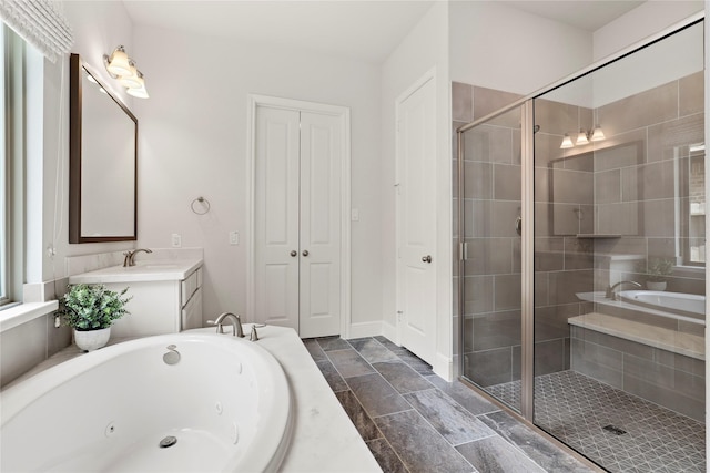 bathroom with vanity and independent shower and bath