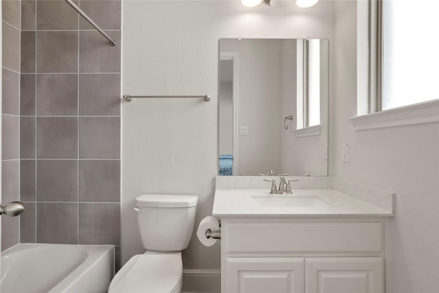 full bathroom featuring vanity, toilet, and tiled shower / bath combo