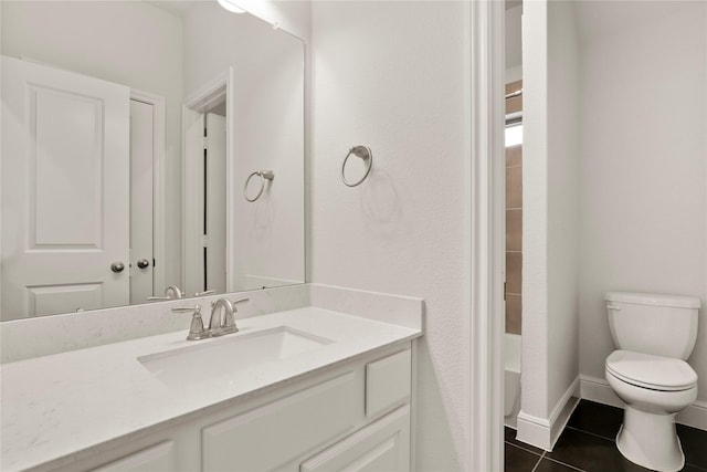 bathroom featuring tile patterned floors, vanity, and toilet