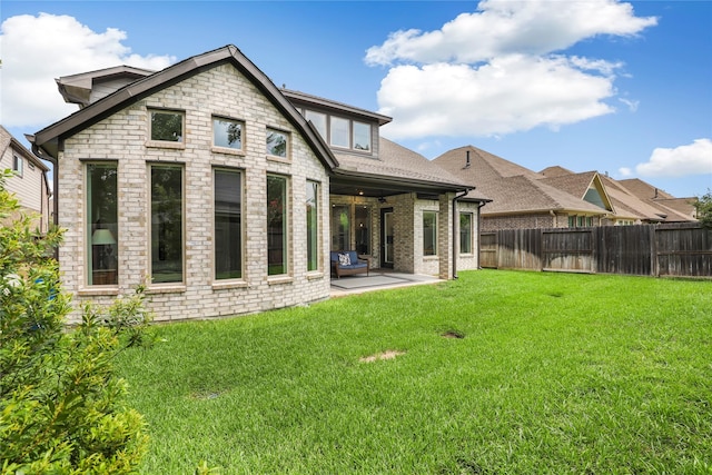 back of house featuring a patio area and a yard