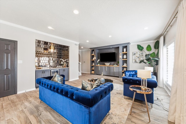 living room with light wood-type flooring, indoor bar, wine cooler, and crown molding