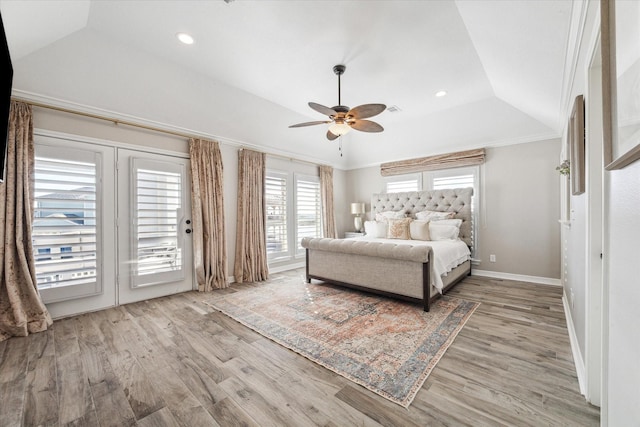 unfurnished bedroom featuring access to outside, a raised ceiling, ceiling fan, ornamental molding, and wood-type flooring