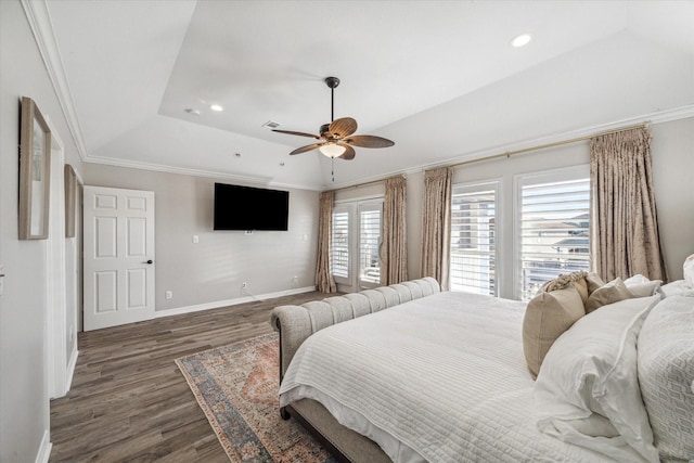 bedroom featuring a raised ceiling, ceiling fan, dark wood-type flooring, and crown molding