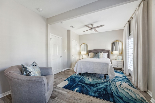 bedroom with light hardwood / wood-style floors and ceiling fan