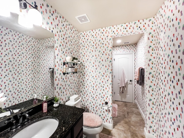 bathroom featuring tile patterned floors, vanity, and toilet