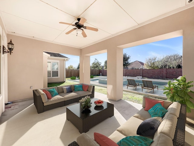 view of patio featuring outdoor lounge area, ceiling fan, and a fenced in pool